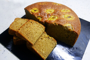 Banana cake is freshly cooked and will be served. Decorated with slices of banana on top.
