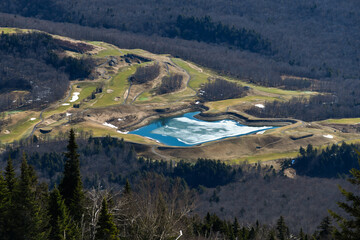 View to the lake down to the valley at spring time skiing in mid April at Stowe Mountain resort, VT