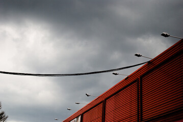 shopping mall wall and street lights against stormy sky