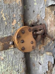 old metal padlock on the door with paint peeling off, paint coming off the door, retro padlock, vintage