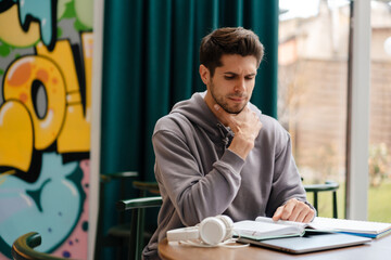 Smiling young man reading book