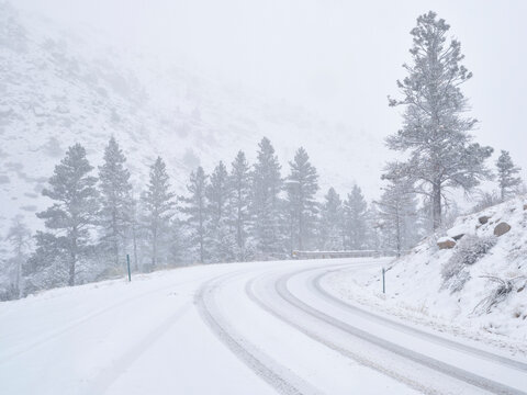 winter travel in Colorado Rocky Mountains - highway 14 in Poudre Canyon in a heavy early spring snowstorm