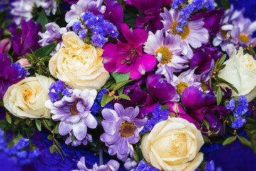 Blue, white and purple flowers in a bouquet. Background flower image with blue shades.