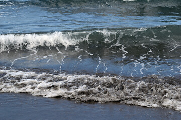 Waves Breaking on Dark Sandy Beach in Canary Islands 