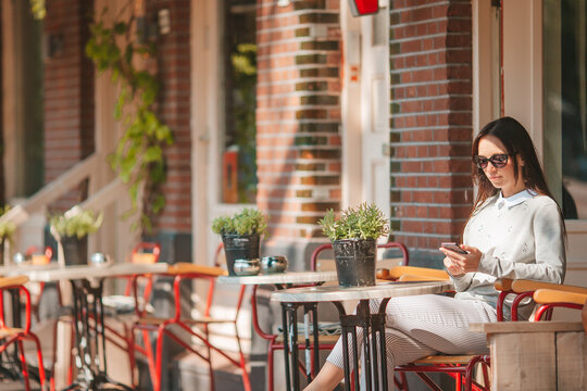 Woman having breakfastin outdoor restaraunt