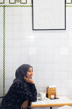 Black Muslim Woman in cafe