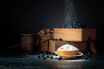 Blueberry muffins and berries in a wooden box.