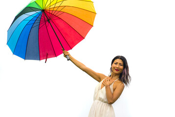 attractive and happy Asian woman holding rainbow colorful umbrella or parasol  smiling playful isolated on white background in beauty and freedom concept