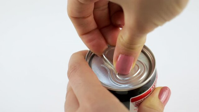 Lviv, Ukraine - April 22, 2021: woman hands open metal coca cola can bottle close up