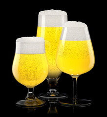 Set of fresh light beer glasses with bubble froth isolated on black background.