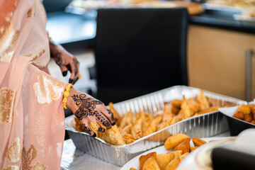 Woman handling samosas  