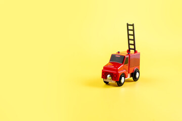 Children's toy, car on a yellow background. Fire engine. Concept. Isolate. Copy space.