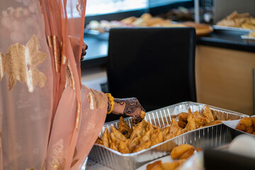 Woman handling samosas