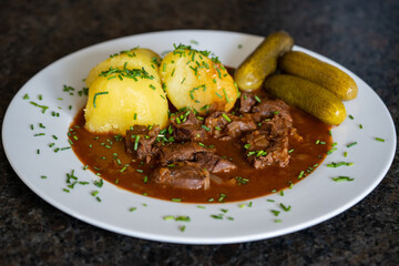 ready to eat - delicious goulash of wild with potatoes, pickles and chives