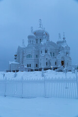 Belogorsk monastery in the evening on the mountain in winter, covered with white snow and frost. Belogorye, Perm Territory, Ural, Russia