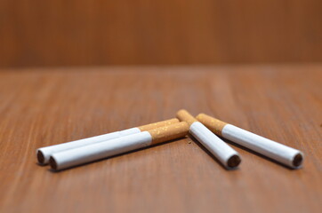 Close-Up Of several Cigarette on wooden background