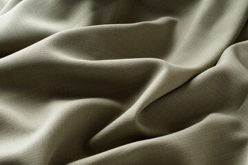Abstract background, gray luxurious fabric lies in wavy folds, close-up. Elegant design. Texture fabric shimmers in the soft light. Silky, wrinkled, dark fabric