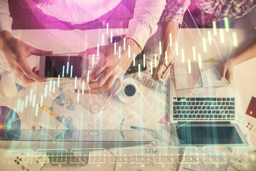 Double exposure of man and woman working together and financial chart hologram drawing. market analysis concept. Computer background. Top View.