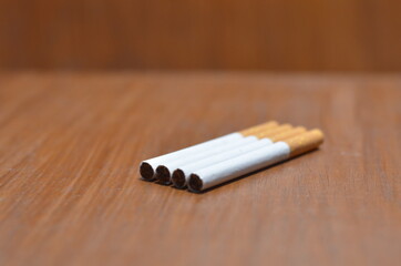 Close-Up Of several Cigarette on wooden background