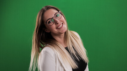 Young pretty woman in her mid-20s laughs at the camera - studio photography