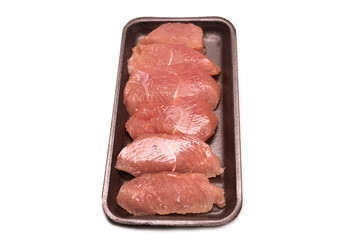 Turkey fillet in a black plastic container isolated.