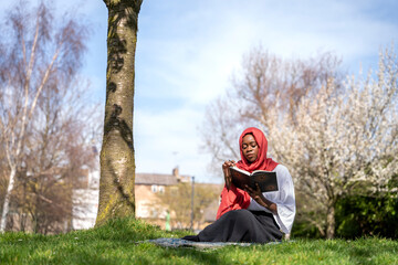 Black Muslim woman in the park 