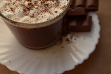 a cup of hot drink, with marshmallows, chocolate and cinnamon. 
