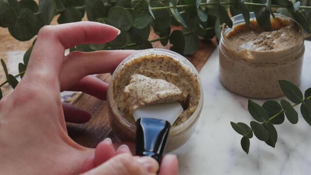 Natural face or body coffee scrub with eucalyptus branches