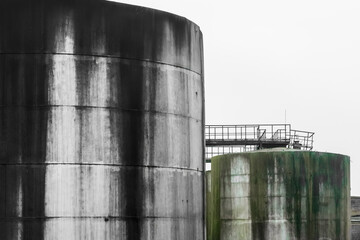 Old fuel oil tanks with fuel oil stains at an abandoned industrial plant