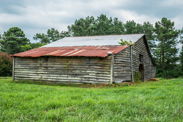 Abandoned barn in a farm field