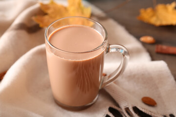 Cup of cocoa with straw on a dark wooden background