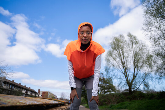 Black Muslim woman runner on the canal