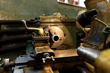 A lathe with a blank in the spindle. Old equipment at the factory from the mid-20th century.