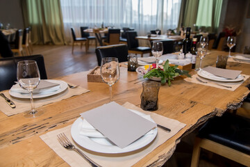 the interior of the cafe is a table with appliances and glasses ready for a buffet, an empty restaurant hall without people