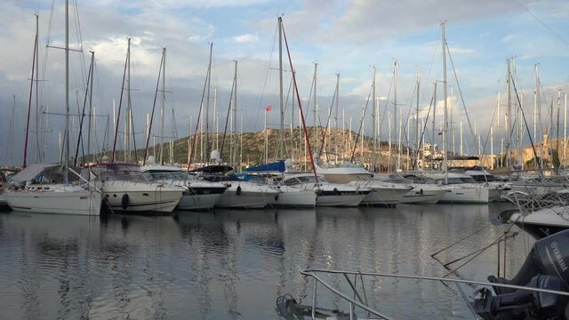 Cesme, Izmir, Turkey - January 2021: Sailing yachts at the dock. Beautiful yachts are moored in the port. Many beautiful yachts.