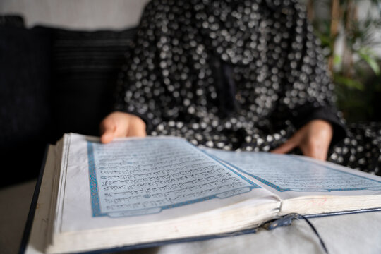 Black Muslim Woman studying and reading quran