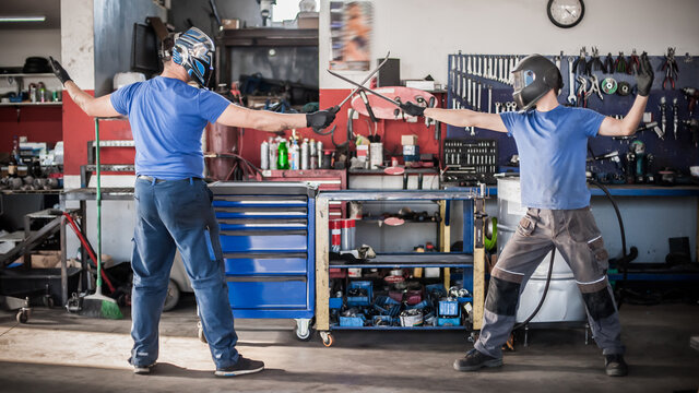 Funny Workers. Car Mechanic Posing With Their Tools In Workshop