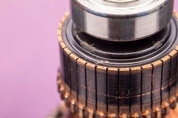 Copper commutator bar of the electric motor close up. Electric motor rotor. - obrazy, fototapety, plakaty