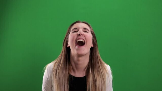 Young woman laughs very loudly - studio photography