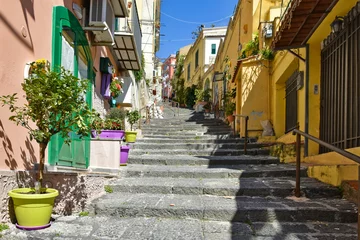A narrow street between old buildings in the city of Naples in Italy.