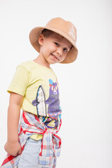 Funny cute little adorable caucasian boy posing in studio on white background