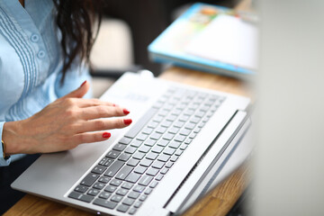 Fototapeta na wymiar Close-up of modern grey laptop standing on wooden desktop