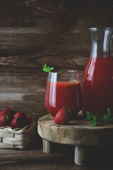 Close up view of two glasses of homemade refreshing strawberries juice nectar drink and mint