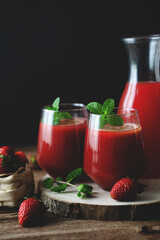 Close up view of two glasses of homemade refreshing strawberries juice nectar drink and mint