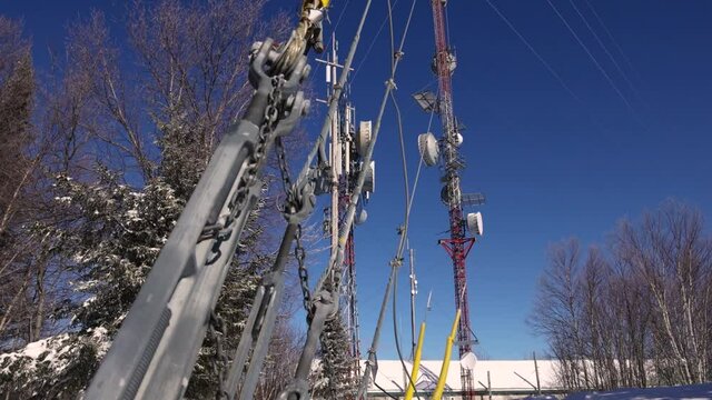 A video showing the equipment and wires at the telecommunication signals base towers, located in snow and trees, causing electromagnetic pollution.