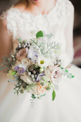 Gorgeous bride in robe posing and preparing for the wedding ceremony face in a room