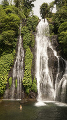 Fototapeta na wymiar Banyumala Waterfall in a jungle sourrounding on Bali Island, Indonesia.