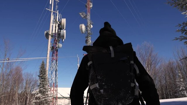 Exploration video featuring a young documentarian walking near the telecommunication signals towers, with transmitters attached to them.