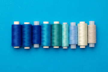 Many colored spools of threads as a background
