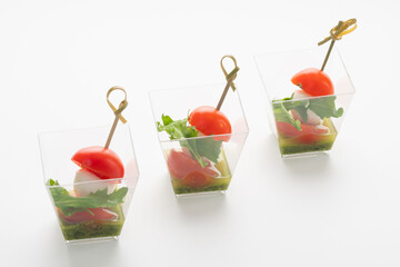 Traditional caprese salad in a glass on a white background. Catering. Delivery